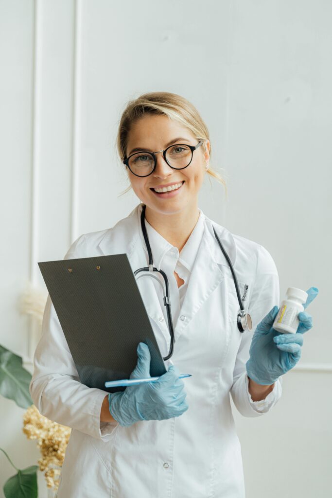 A cheerful female doctor holding a clipboard and medicine, conveying professionalism.